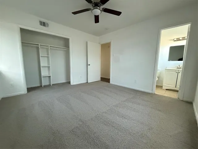 a view of empty room with ceiling fan