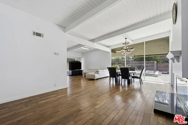 a view of a dining room with furniture wooden floor and chandelier