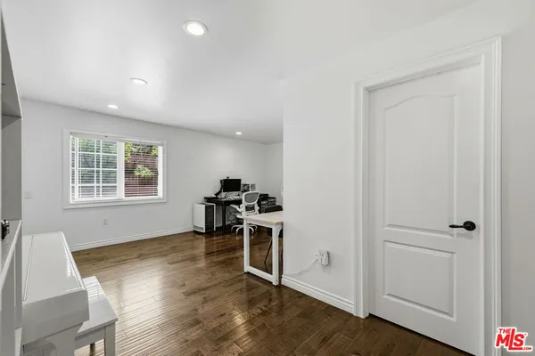 a large bed sitting in a bedroom next to a window