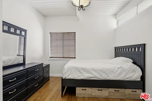 a view of a hallway and a livingroom with furniture