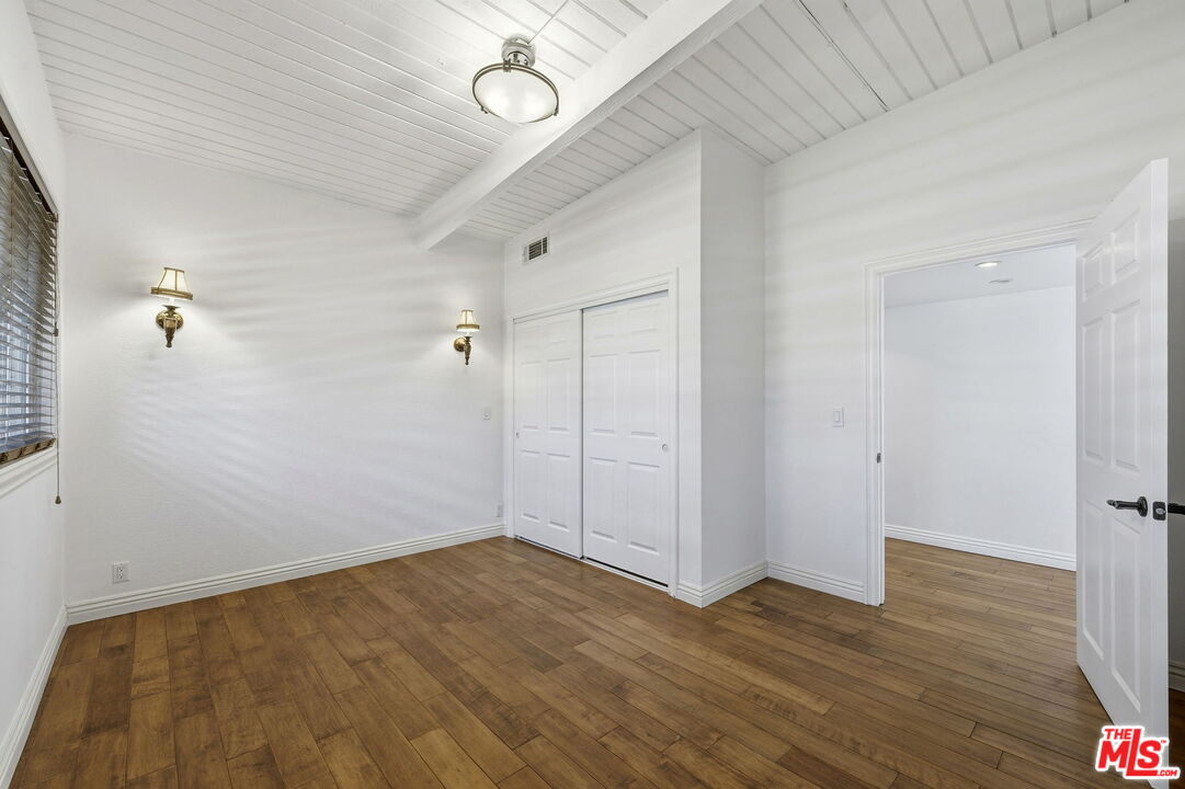 18342 Blackhawk Street Porter Ranch, CA 91326 - Photo 33 of 56 a view of a room with wooden floor and white walls