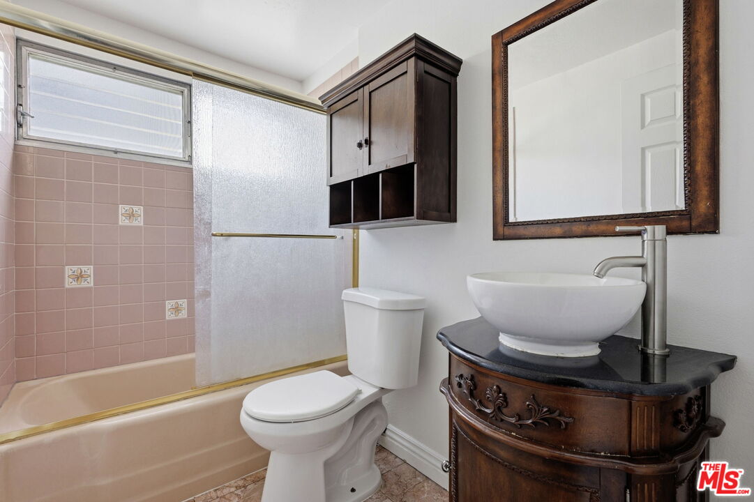 18342 Blackhawk Street Porter Ranch, CA 91326 - Photo 41 of 56 a bathroom with a toilet sink and mirror