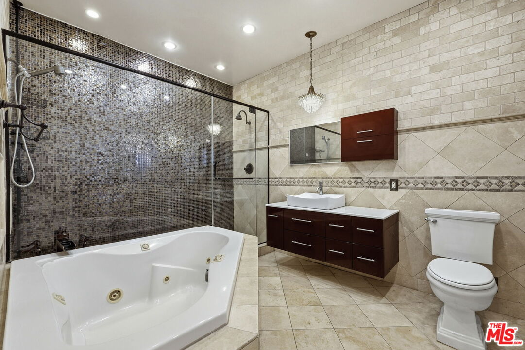 18342 Blackhawk Street Porter Ranch, CA 91326 - Photo 43 of 56 a bathroom with a sink a toilet and a bathtub