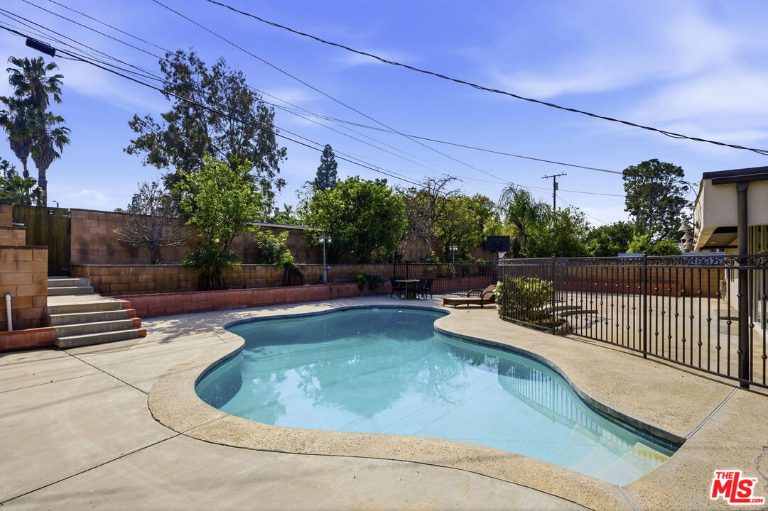 18342 Blackhawk Street Porter Ranch, CA 91326 - Photo 51 of 56 a view of a swimming pool with a patio