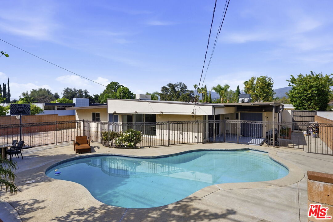 18342 Blackhawk Street Porter Ranch, CA 91326 - Photo 52 of 56 a view of a swimming pool with a patio