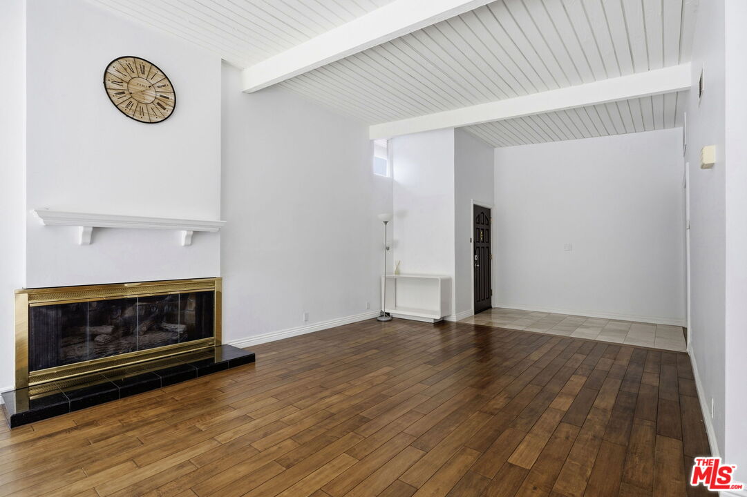 18342 Blackhawk Street Porter Ranch, CA 91326 - Photo 6 of 56 a view of an empty room with wooden floor and a fireplace