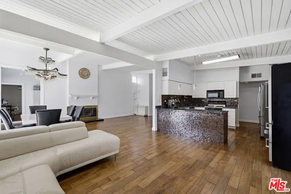 a kitchen with stainless steel appliances granite countertop a sink stove and microwave