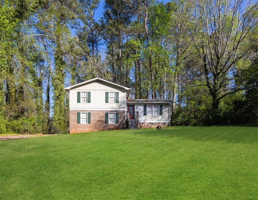 4641 Lucerne Valley Road Southwest Lilburn, GA 30047 - Photo 1 of 1 a view of a house with a yard