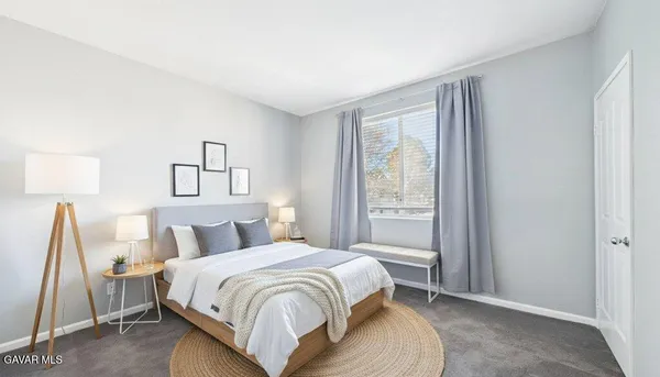 a bedroom with a bed and a night stand