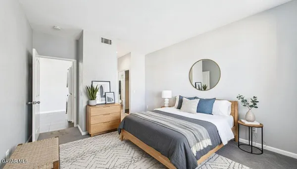 a bedroom with a bed and a mirror