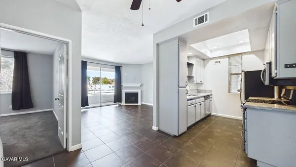 a kitchen with cabinets and refrigerator