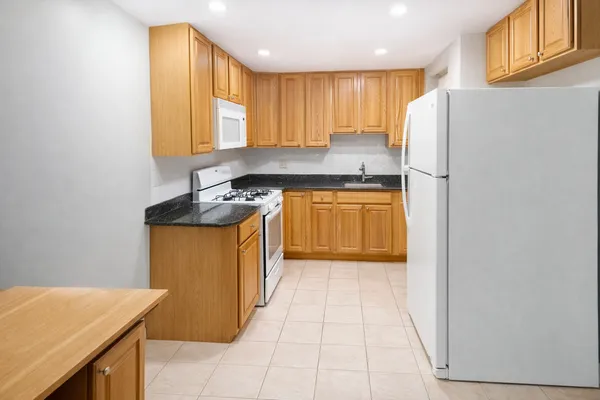 a kitchen with stainless steel appliances granite countertop a refrigerator sink and cabinets