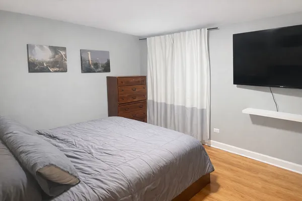a bedroom with a bed and a flat screen tv