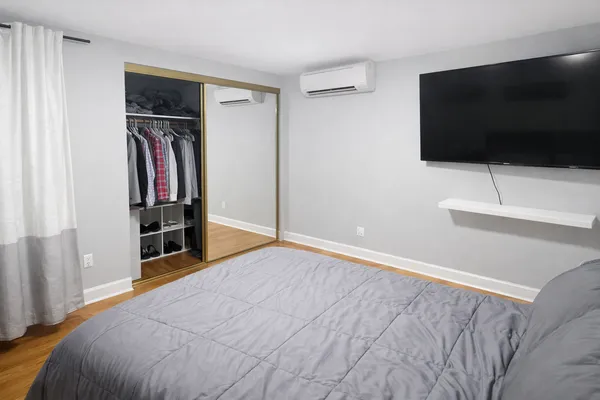 a bedroom with a bed and a flat screen tv
