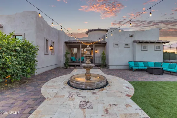 a view of a patio with table and chairs potted plants