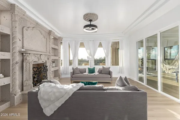 a living room with furniture and a floor to ceiling window