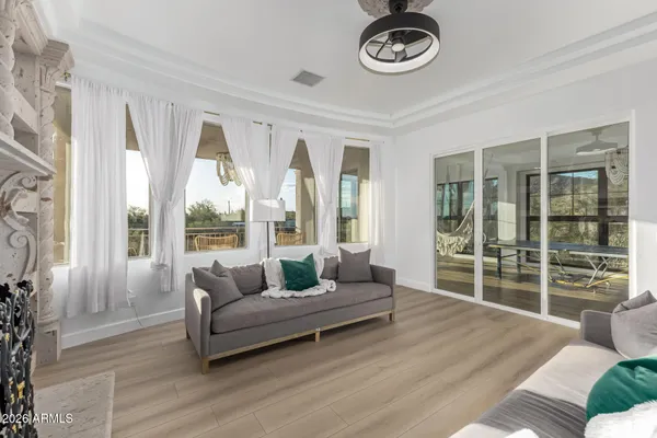 a dining room with wooden floor a chandelier