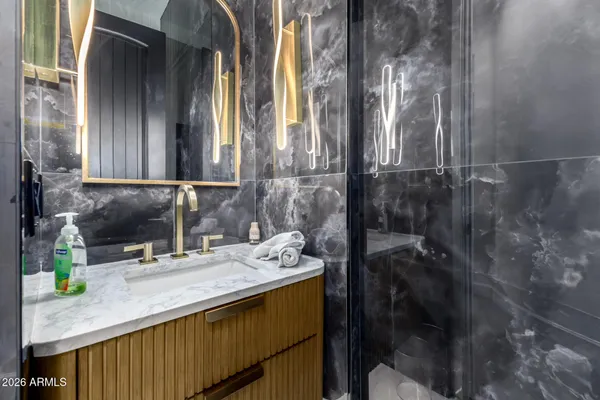 a bed sitting in a spacious bedroom next to a window