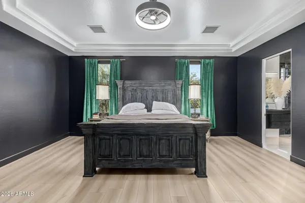 a bedroom with a bed and a mirror