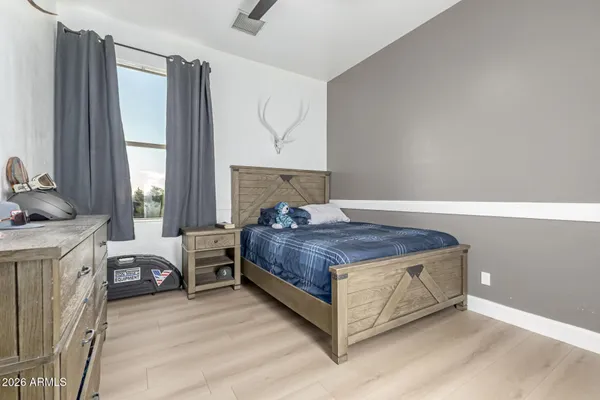 a bedroom with a bed and a view of closet