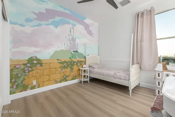 a living room with a bed furniture and a window