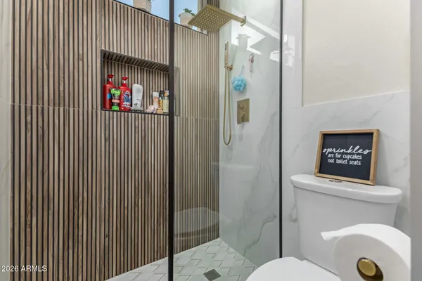 a view of a dining room and livingroom with furniture wooden floor a chandelier