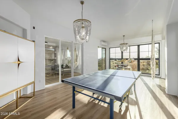 a very nice looking living room with a large window and a chandelier