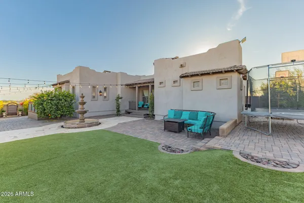 a view of a house with backyard and sitting area