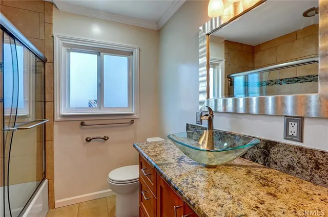 an empty room with wooden floor and a ceiling fan