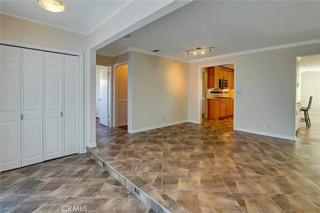 an empty room with entrance and windows