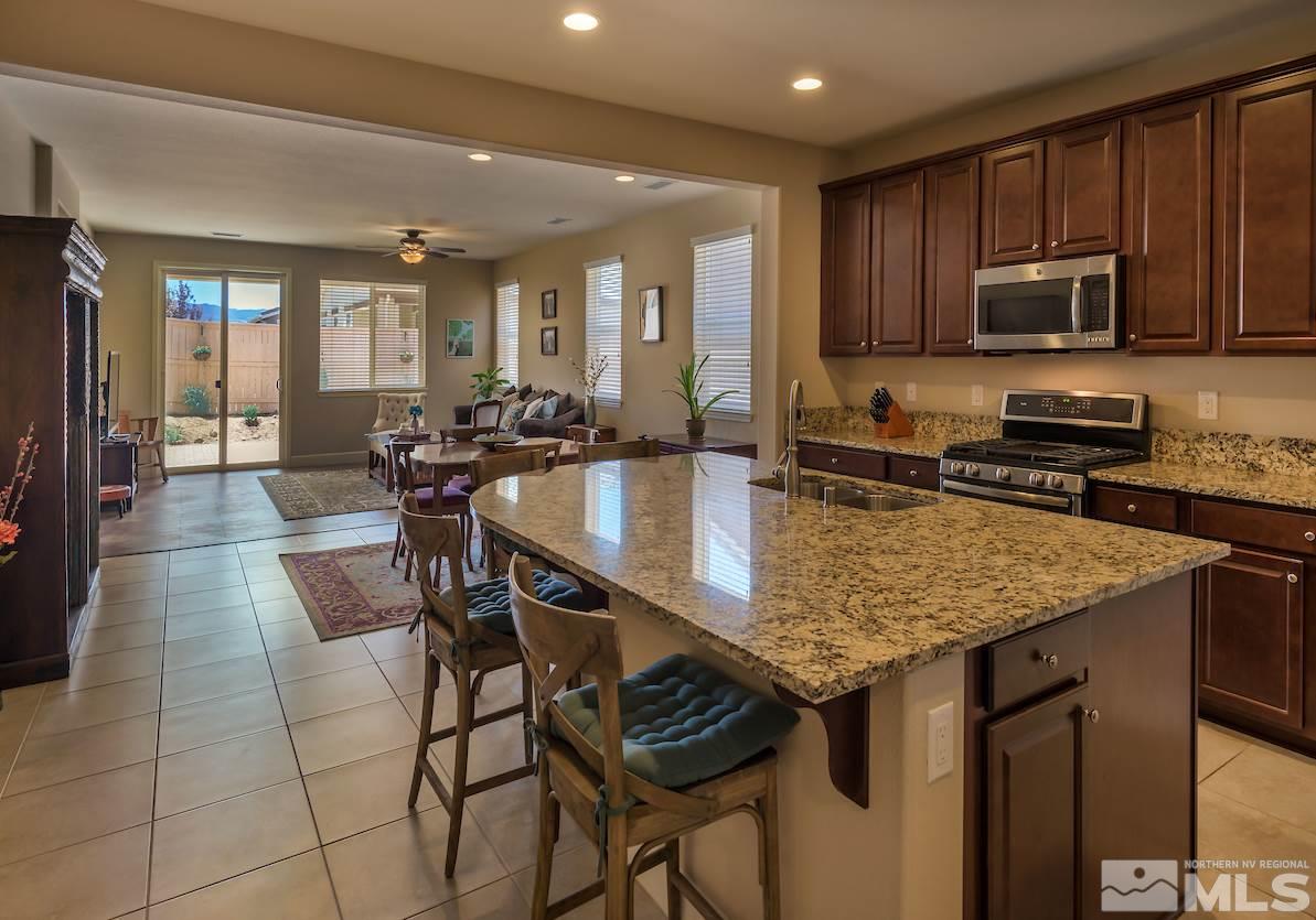 10045 Ignacio Circle Reno, NV 89521 - Photo 2 of 12 a kitchen with stainless steel appliances granite countertop a stove a sink a microwave and refrigerator