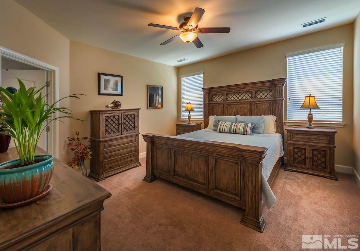 10045 Ignacio Circle Reno, NV 89521 - Photo 7 of 12 a bedroom with a bed and a potted plant