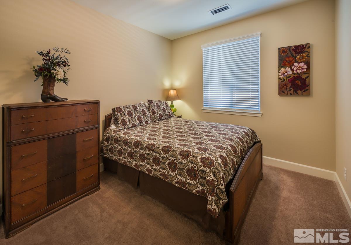 10045 Ignacio Circle Reno, NV 89521 - Photo 10 of 12 a bedroom with a bed and a window