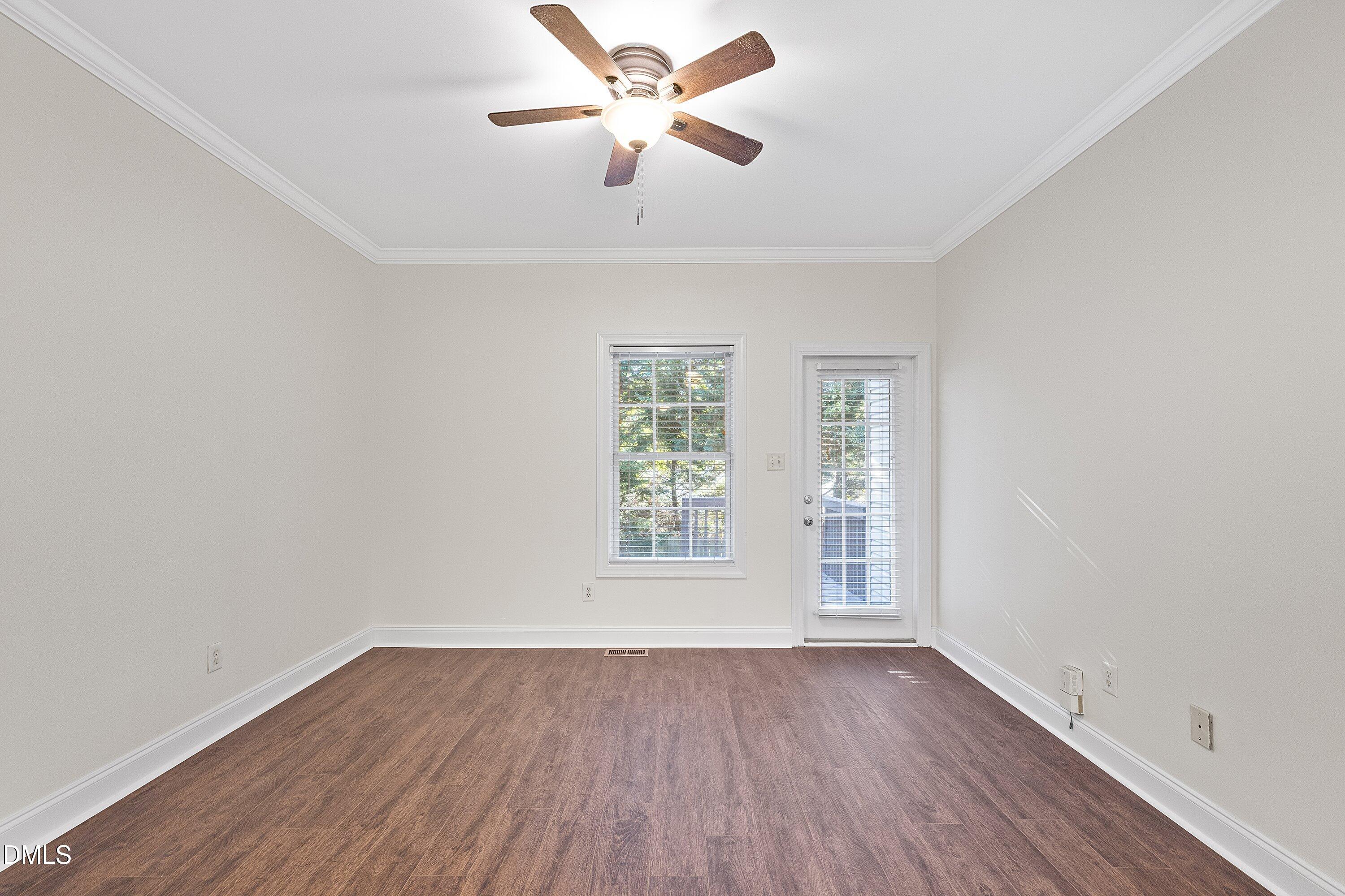4120 Standing Rock Way Raleigh, NC 27604 - Photo 13 of 37 an empty room with wooden floor chandelier fan and windows