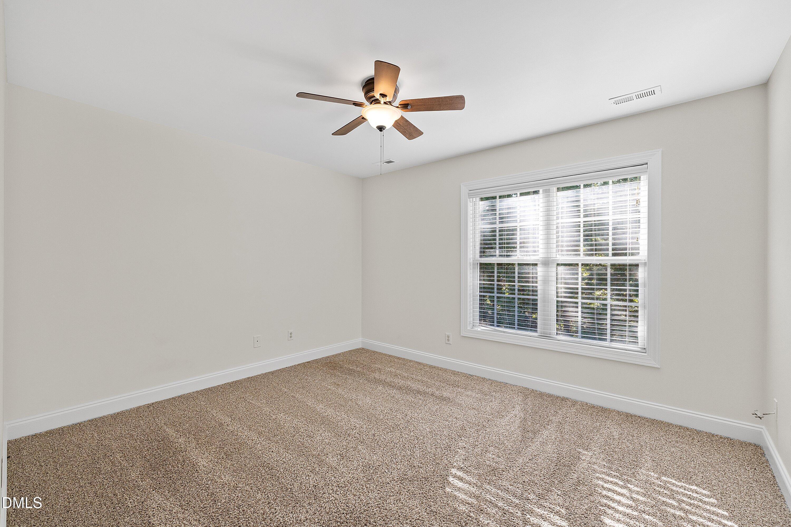 4120 Standing Rock Way Raleigh, NC 27604 - Photo 26 of 37 a view of empty room with wooden floor and fan