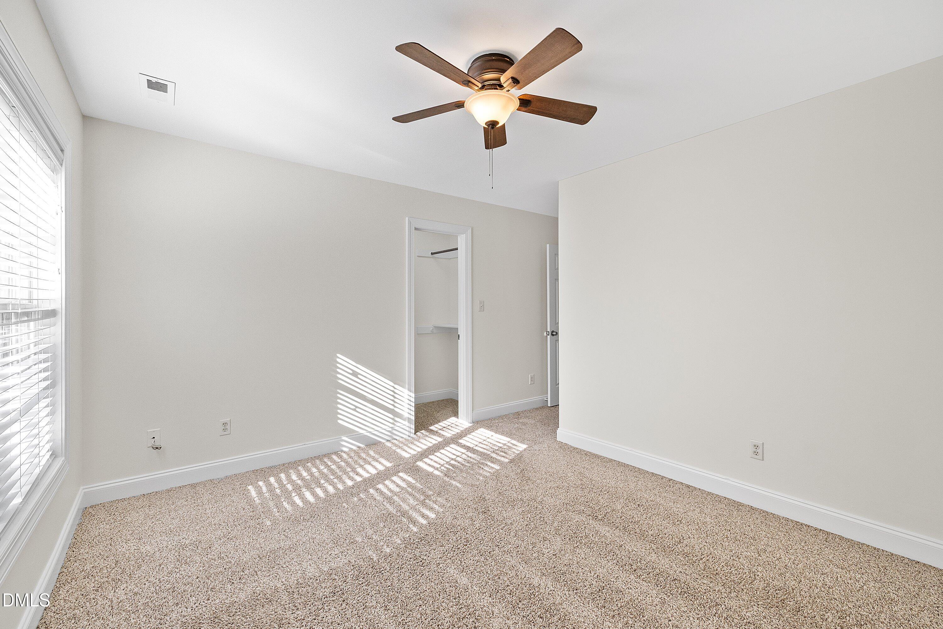 4120 Standing Rock Way Raleigh, NC 27604 - Photo 28 of 37 an empty room with ceiling fan and window