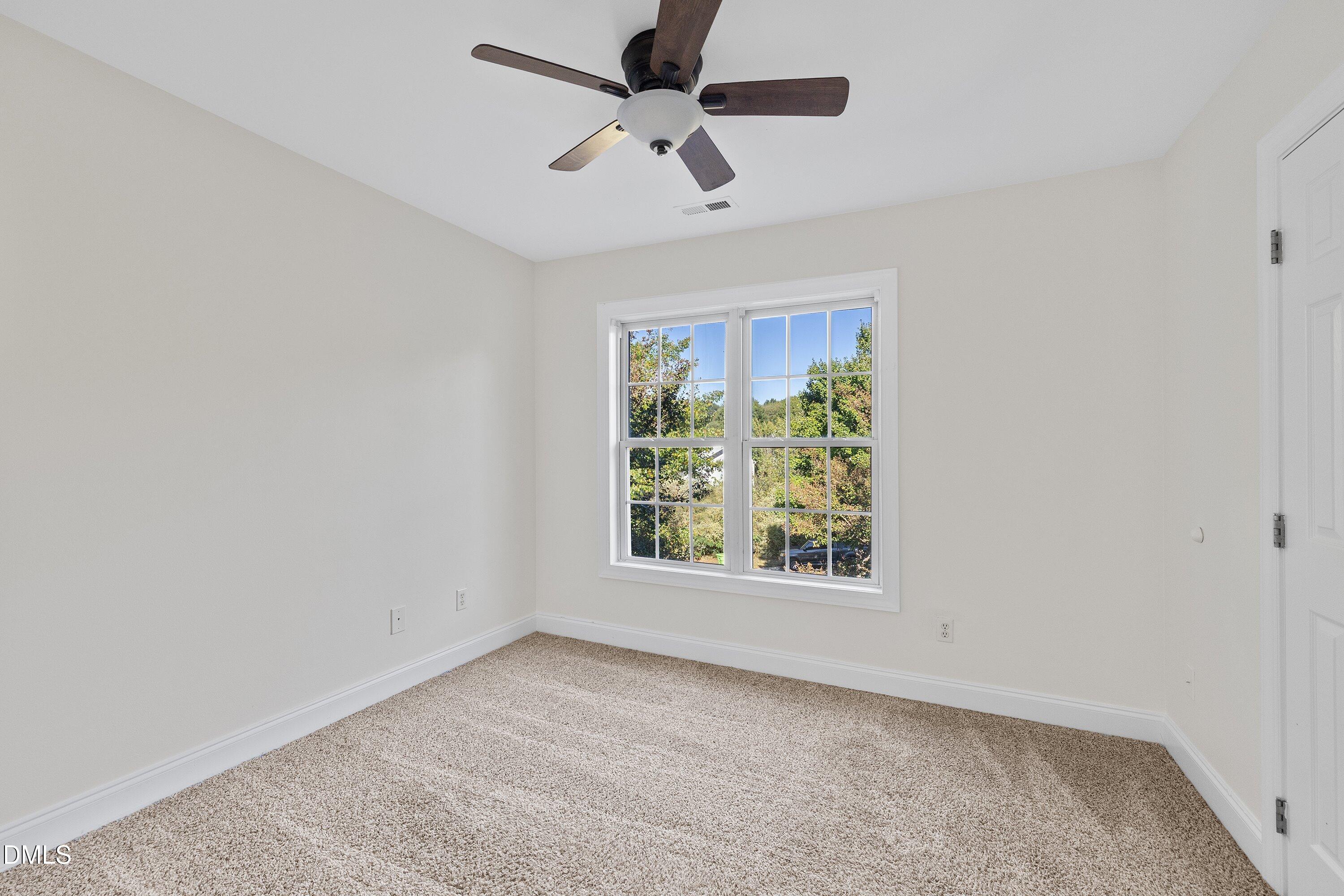 4120 Standing Rock Way Raleigh, NC 27604 - Photo 30 of 37 an empty room with a window and a fan
