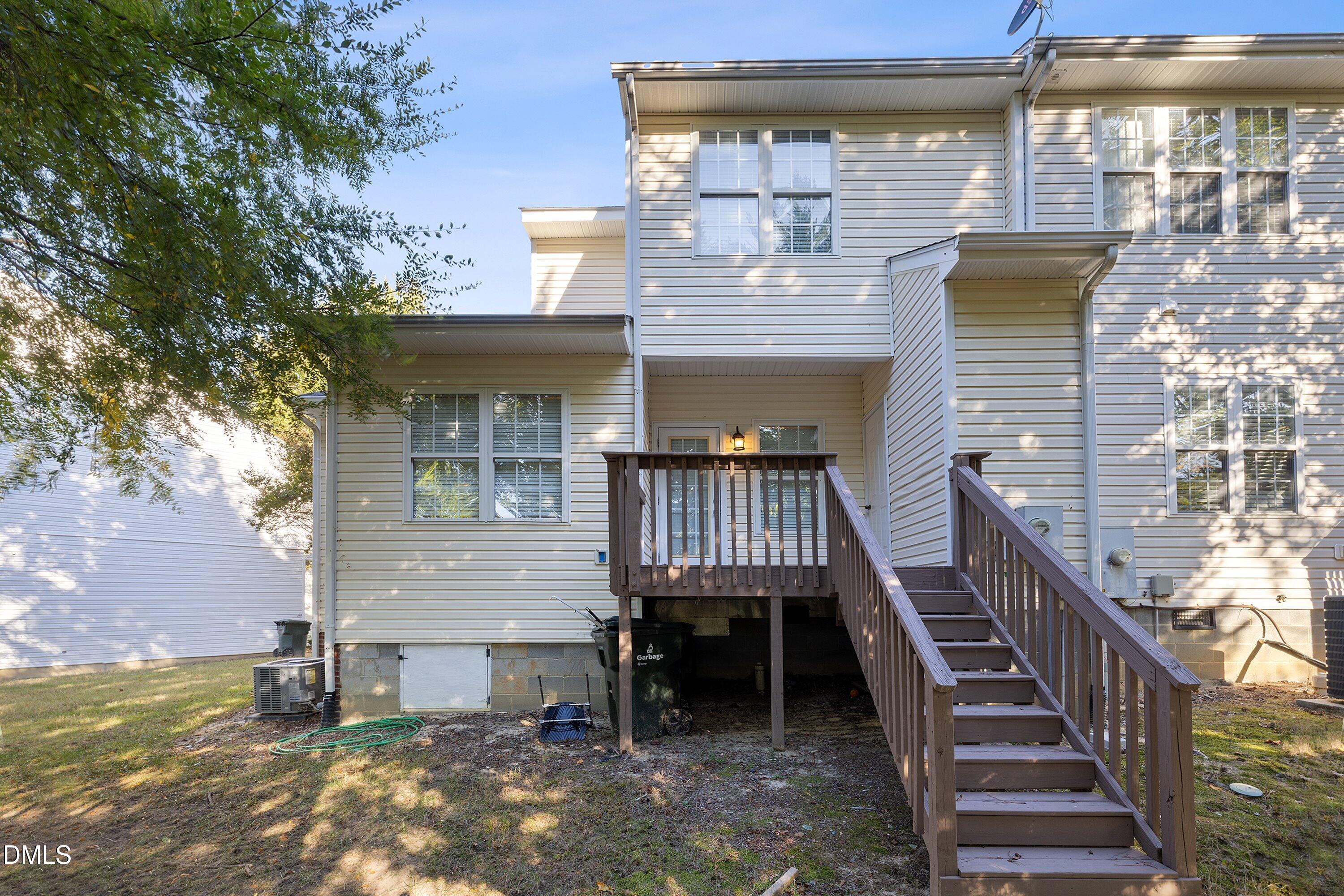 4120 Standing Rock Way Raleigh, NC 27604 - Photo 35 of 37 a front view of a house with wooden stairs and a table