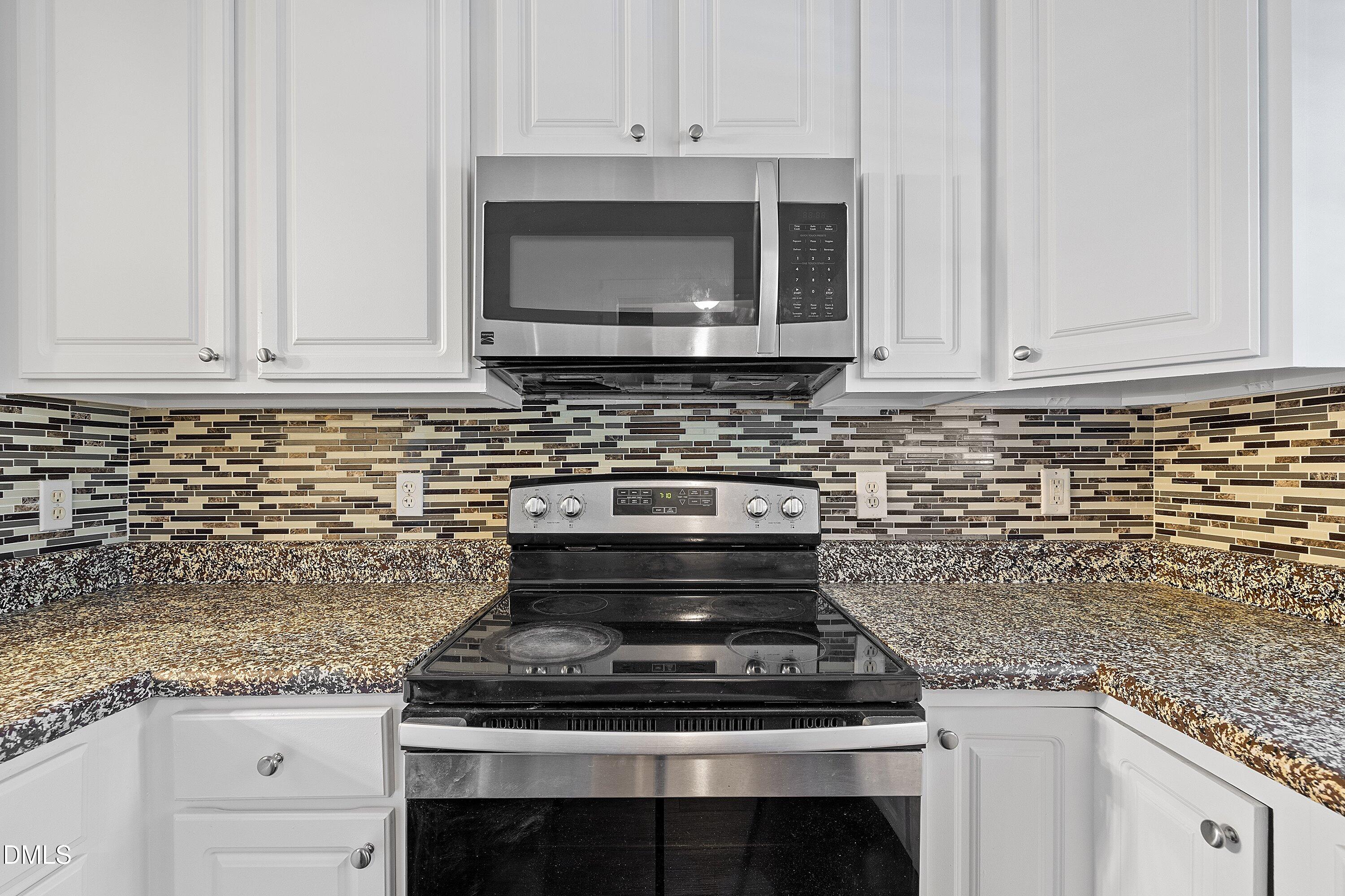 4120 Standing Rock Way Raleigh, NC 27604 - Photo 9 of 37 a kitchen with granite countertop a stove and a sink