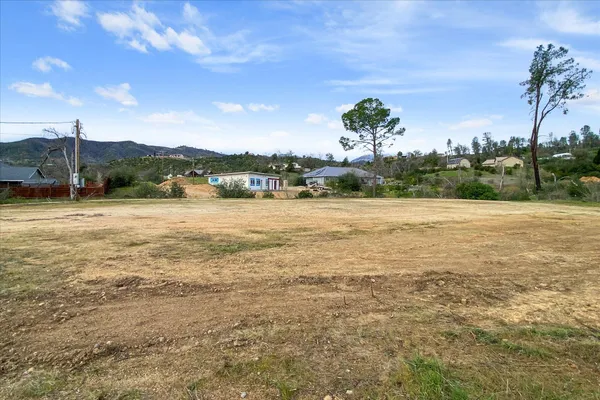 a view of a field with ocean view