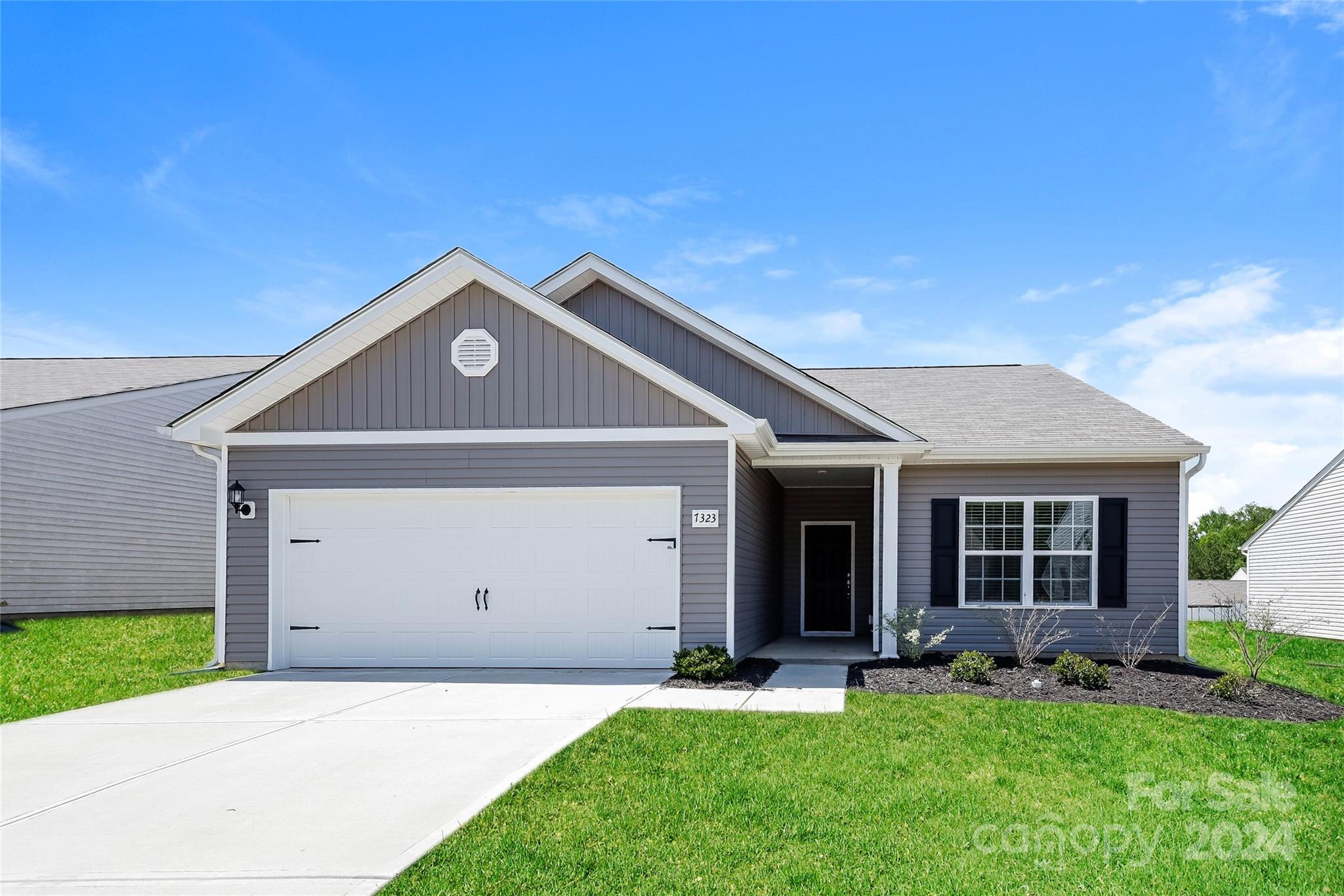 7323 Amberly Hills Road Charlotte, NC 28215 - Photo 1 of 14 a front view of a house with a yard and garage