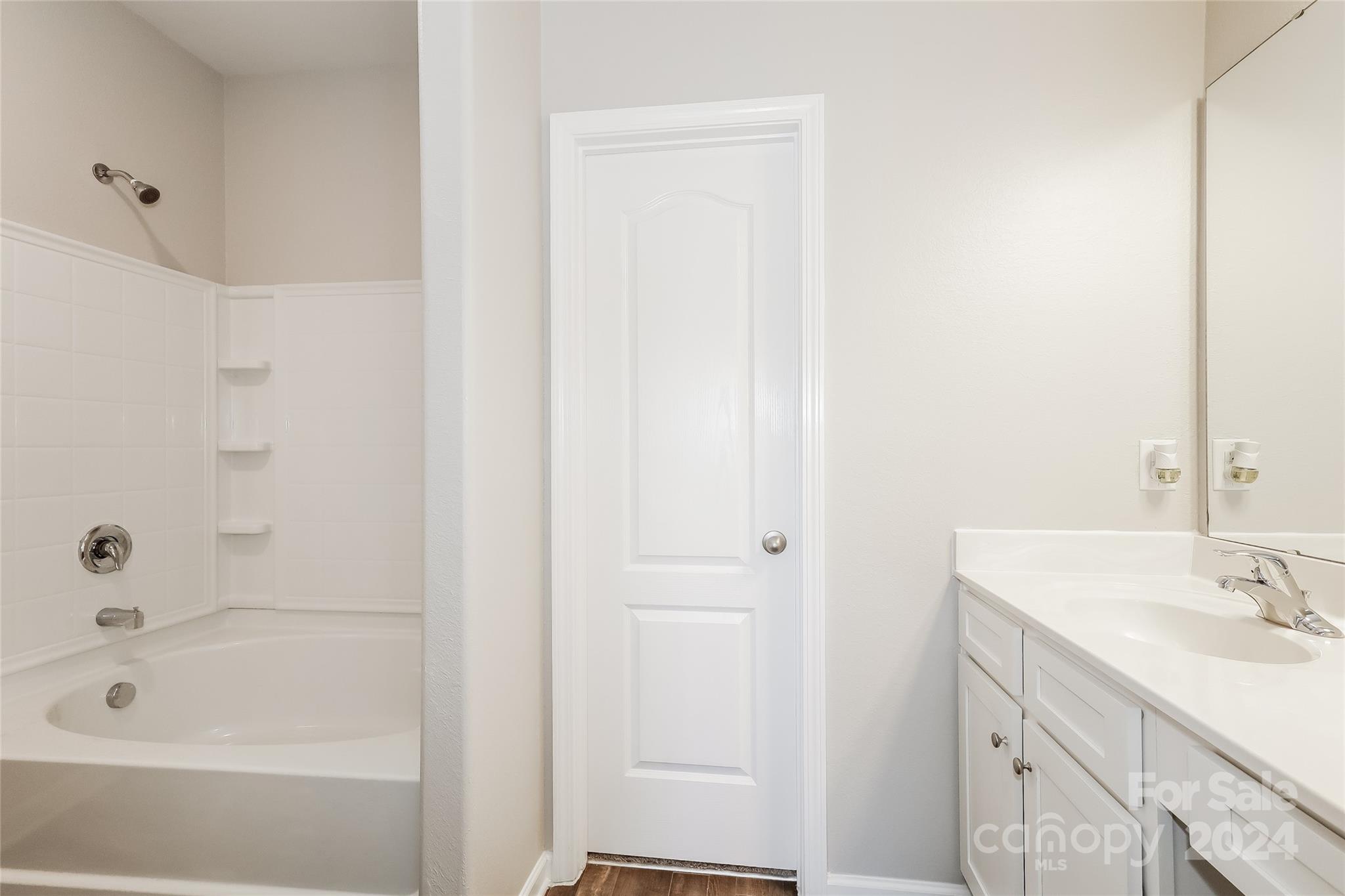 7323 Amberly Hills Road Charlotte, NC 28215 - Photo 11 of 14 a bathroom with a tub sink vanity and a mirror