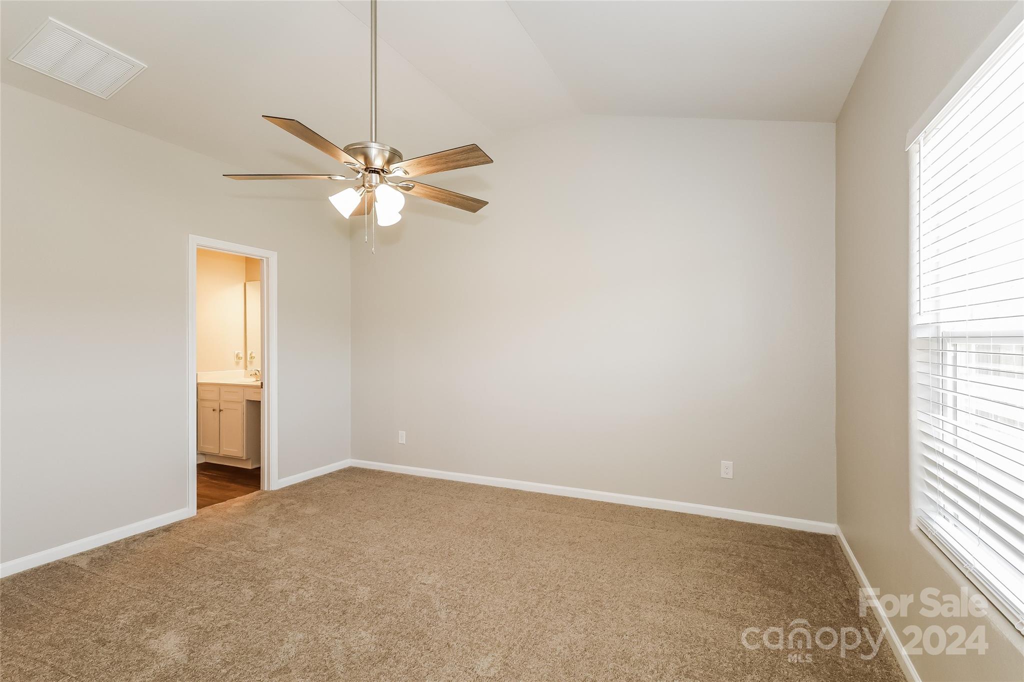 7323 Amberly Hills Road Charlotte, NC 28215 - Photo 12 of 14 an empty room with windows and fan