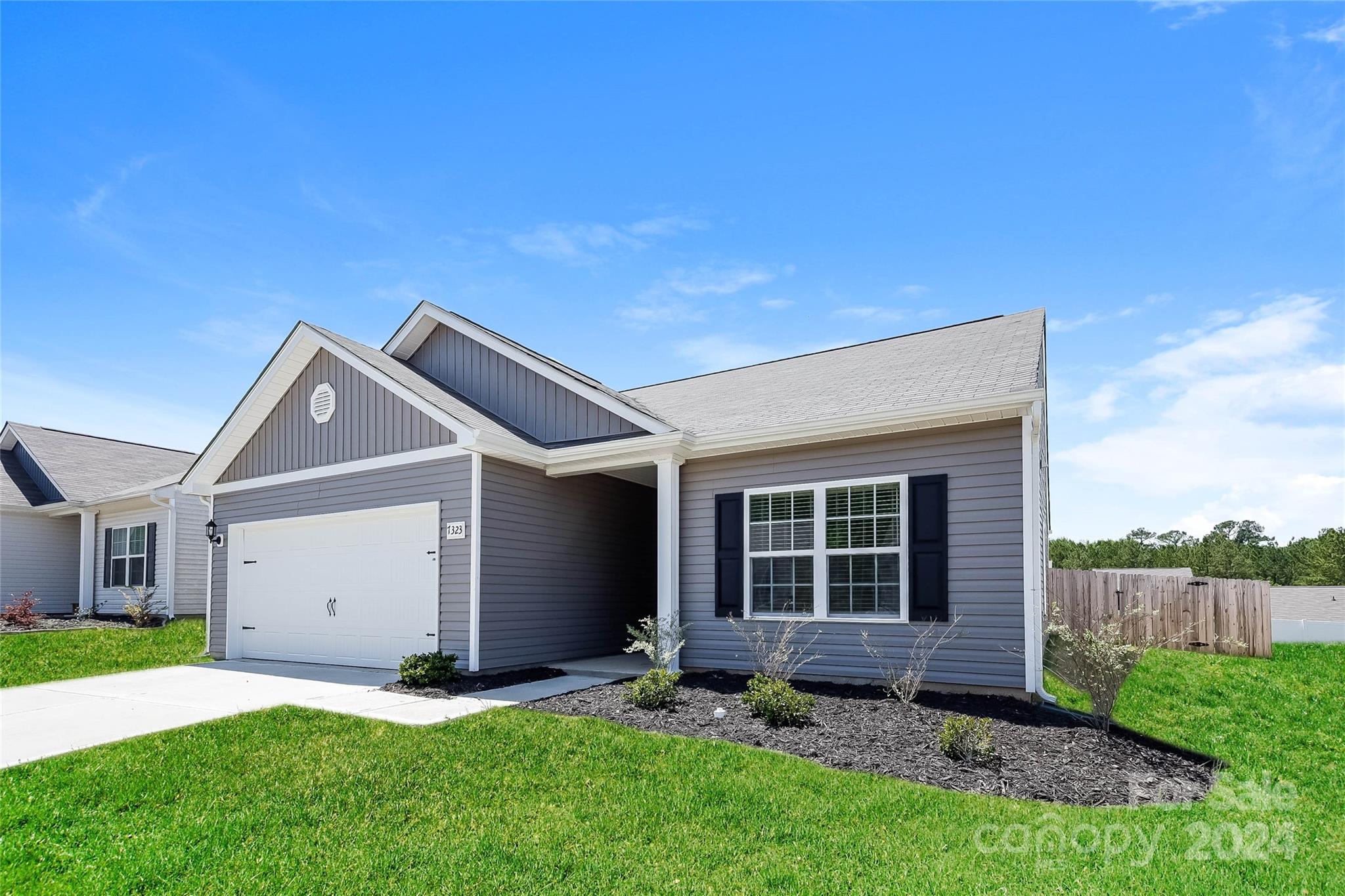 7323 Amberly Hills Road Charlotte, NC 28215 - Photo 2 of 14 a front view of a house with a yard and garage