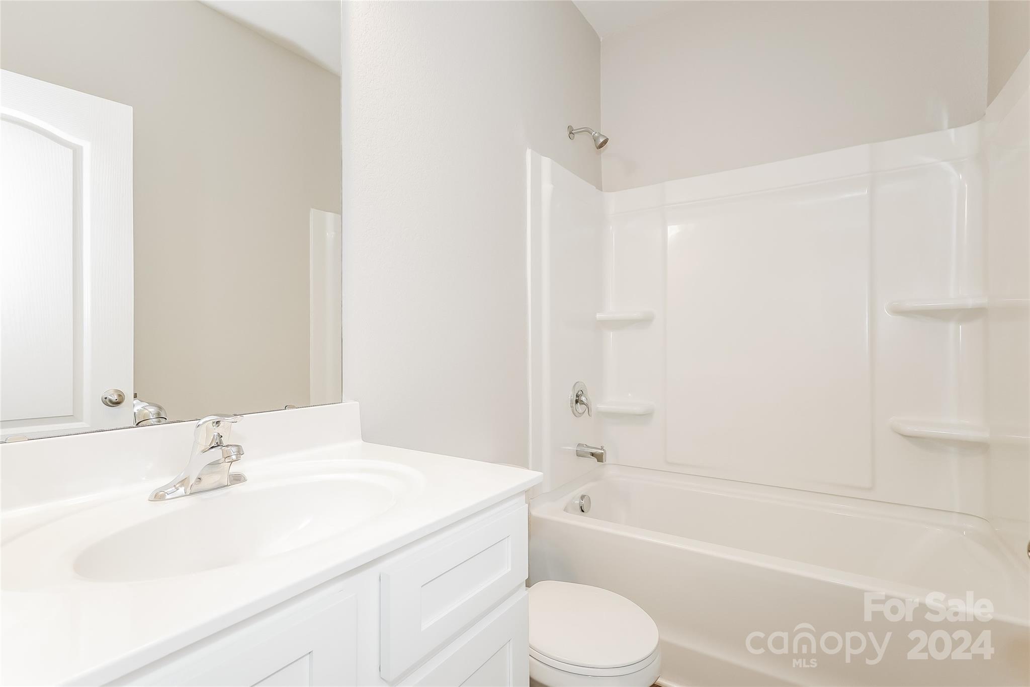 7323 Amberly Hills Road Charlotte, NC 28215 - Photo 3 of 14 a bathroom with a granite countertop sink toilet and shower