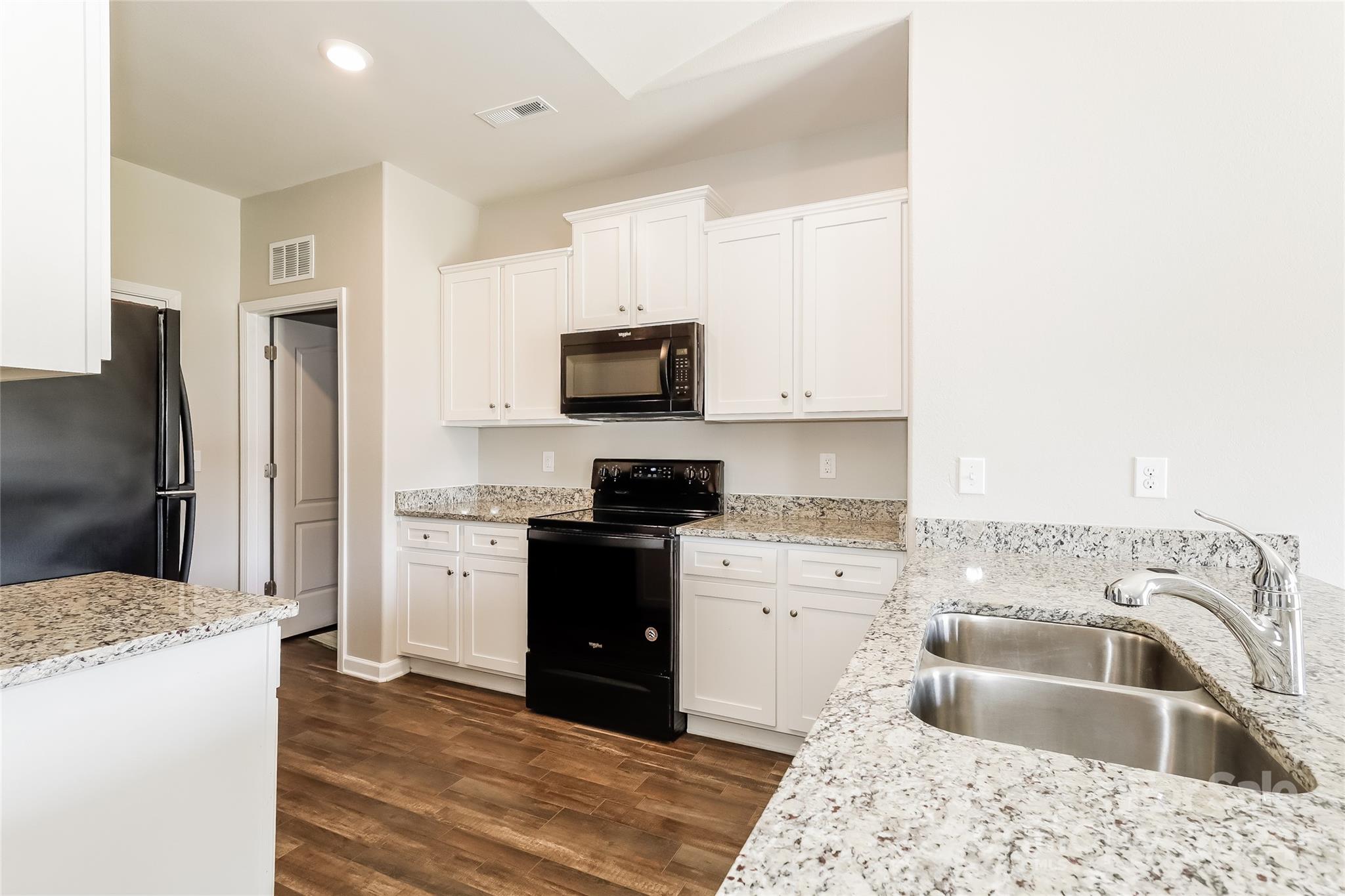 7323 Amberly Hills Road Charlotte, NC 28215 - Photo 9 of 14 a kitchen with a sink stove and refrigerator