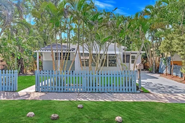 a view of a house with a yard and deck