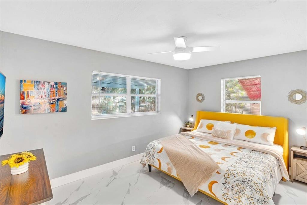 253 Southwest 7th Street, Unit A Dania Beach, FL 33004 - Photo 11 of 22 a bedroom with a bed and a window