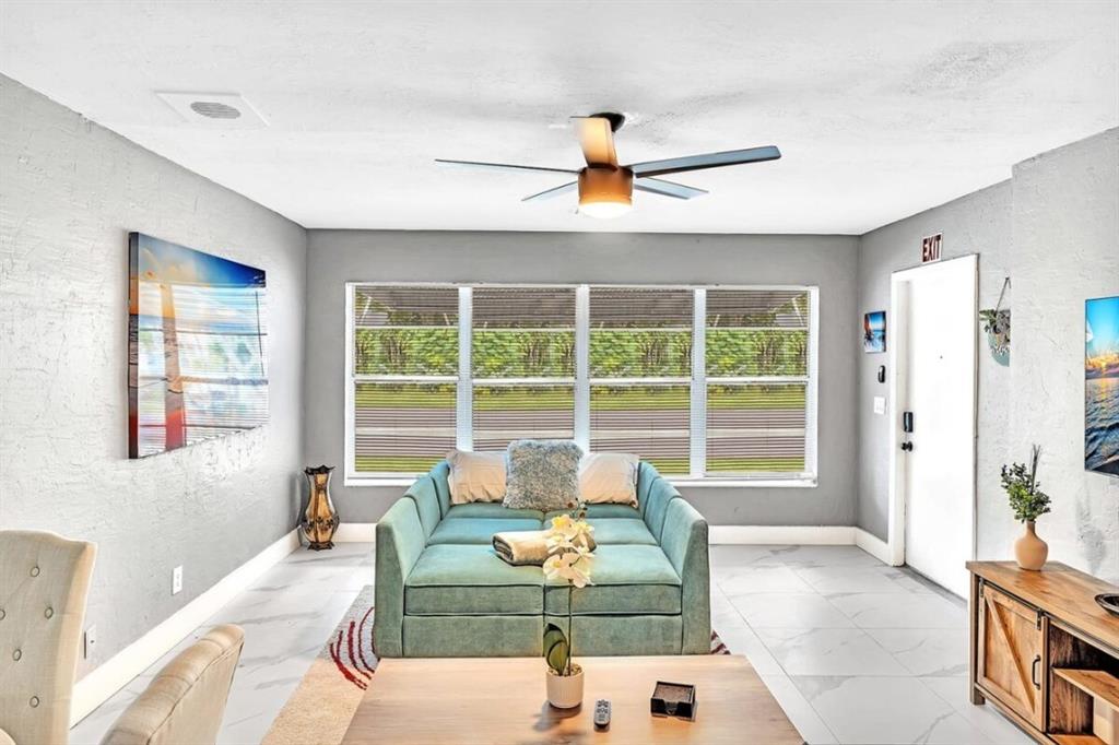 253 Southwest 7th Street, Unit A Dania Beach, FL 33004 - Photo 15 of 22 a living room with furniture and a large window