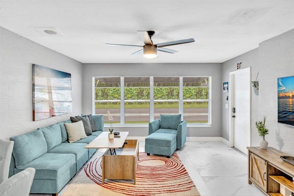 253 Southwest 7th Street, Unit A Dania Beach, FL 33004 - Photo 16 of 22 a living room with furniture and a large window